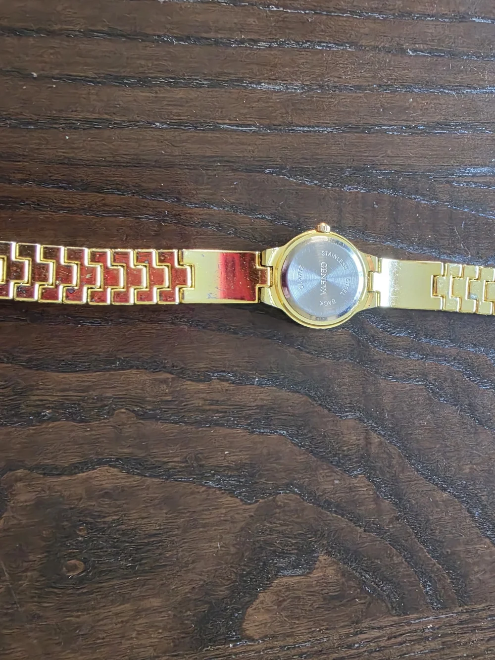 Geneva Gold Tone Women’s Watch with Black and Gold Dial